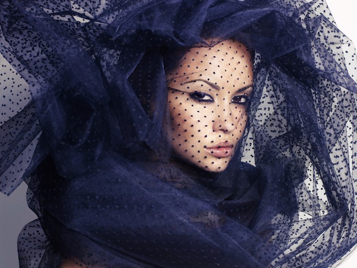 Woman wearing a dark blue polka dot veil