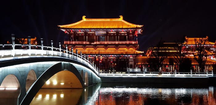 Night view of Tang Paradise Park in Xian, China with illuminated bridge
