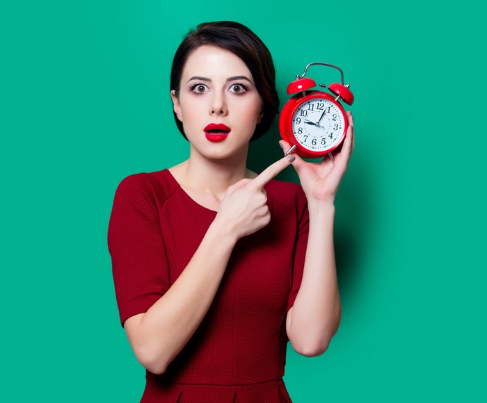 Brunette girl with alarm clock