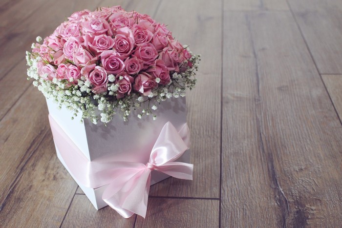 Pink roses in a white box with a pink bow
