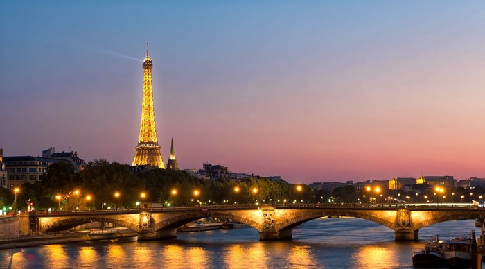 Eiffel Tower and bridge over the Seine River at sunset