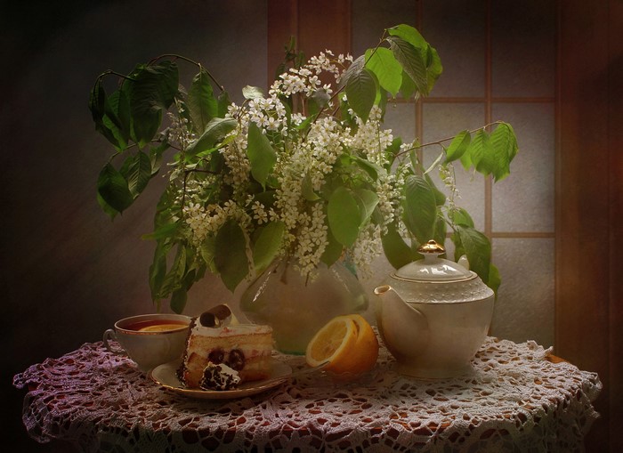 Still-life with cake, tea, and flowering branches