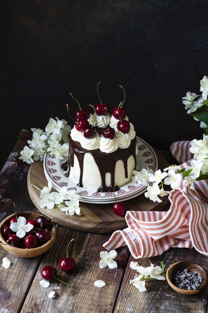Chocolate cake with cherries and whipped cream