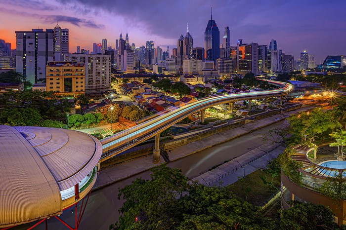 Kuala Lumpur skyline with elevated train at dusk
