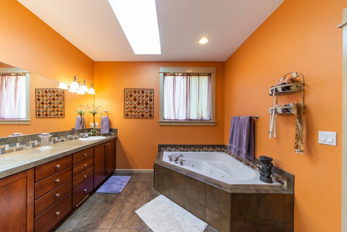 Orange Bathroom with Bathtub and Vanity