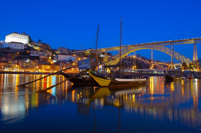 Porto, Portugal: Riverboats and Dom Luís I Bridge at Dusk