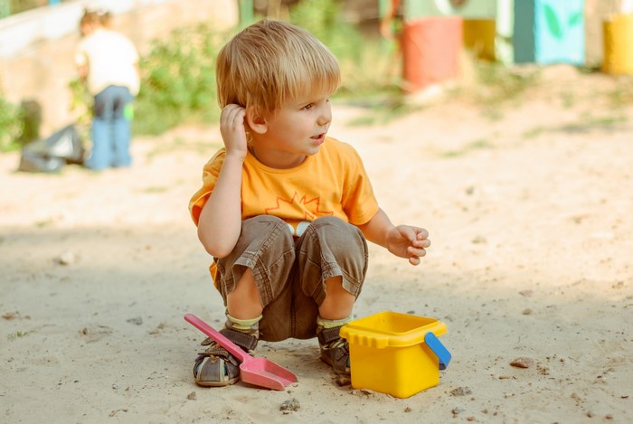 Boy playing with toys in the sand
