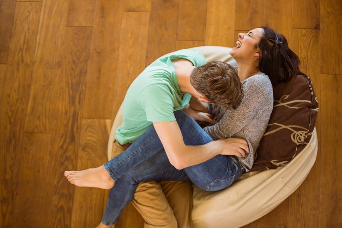 Couple laughing on a beanbag chair