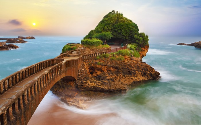 Bridge to a rocky island with trees in Biarritz, France