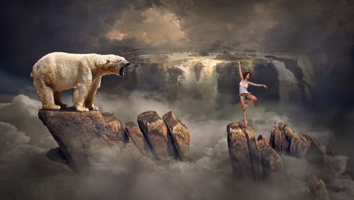 Polar bear and dancer on rocks with waterfalls