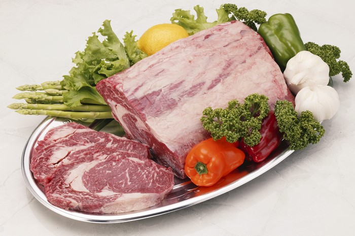 Raw Beef Roast and Sliced Steaks with Vegetables