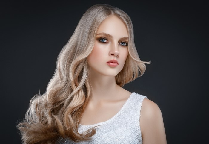 Blonde woman with wavy hair looking to the side