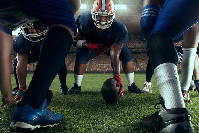 American football players in formation with a ball