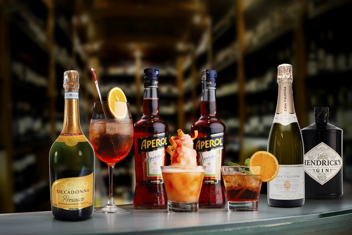 Aperol, Gin, Champagne, and Prosecco Bottles with Cocktails