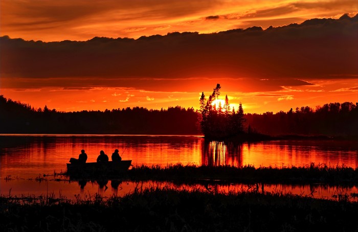Fishing boat at sunset on a lake
