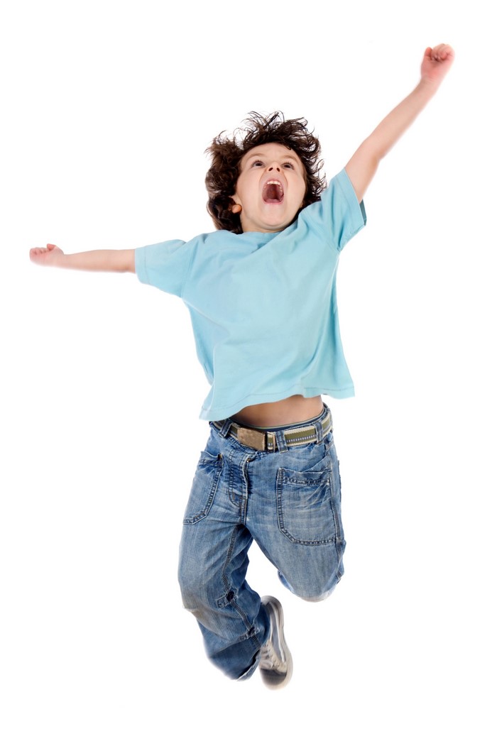 Boy jumping with arms outstretched