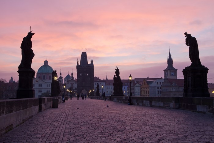 Charles Bridge at dusk with statues and towers, Prague