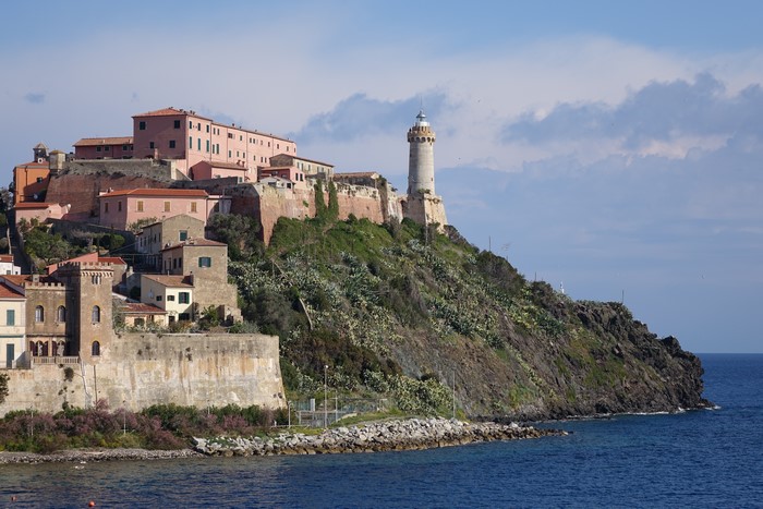 Lighthouse and buildings on a hill overlooking the sea in Portoferraio, Island of Elba