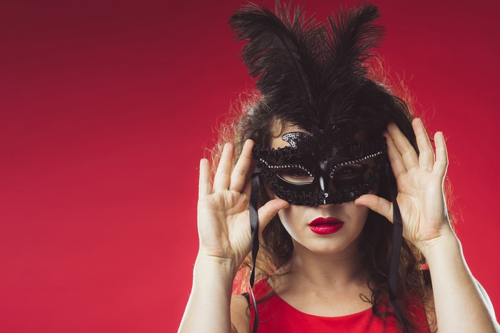 Woman in a black feathered mask