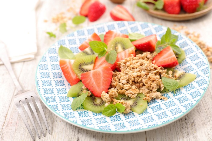 Muesli with Strawberries and Kiwi on a Plate