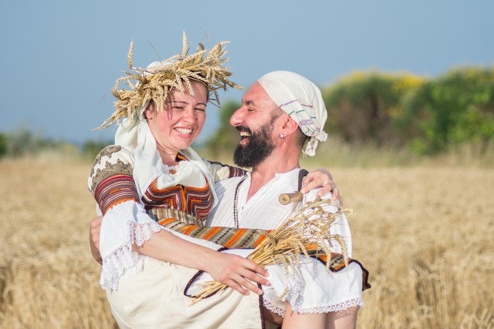 Couple in traditional clothing in a wheat field