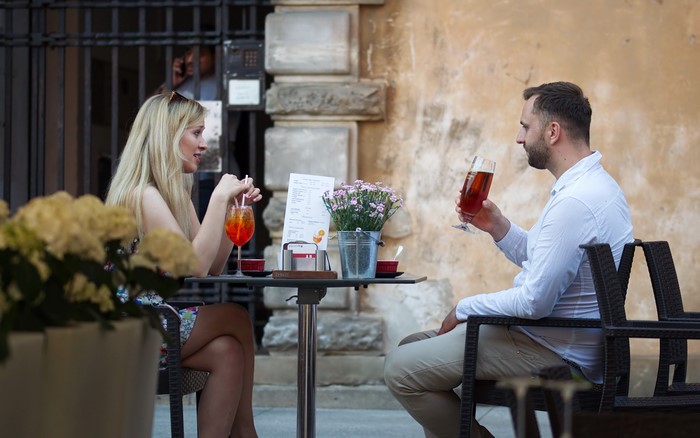 Couple sitting at a cafe table with drinks
