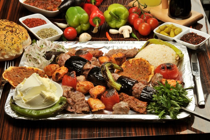 Meat platter with rice, bread, and vegetables