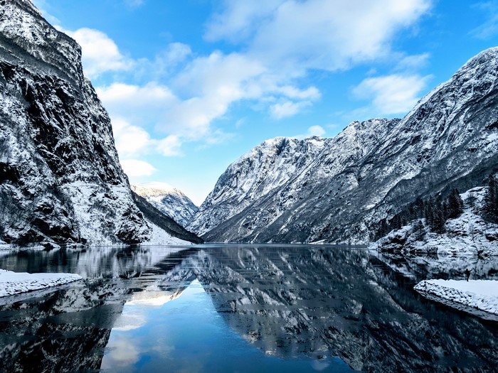 Snowy Fjord in Norway with Mountain Reflections