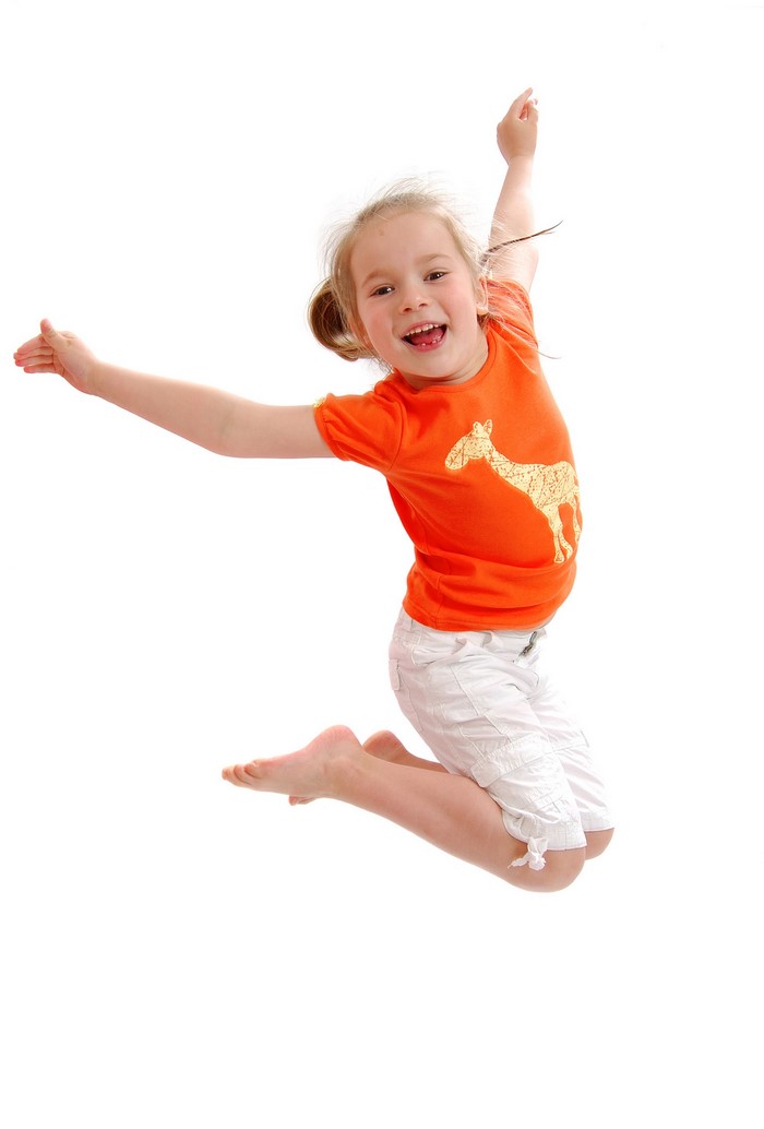 Young girl jumping with arms outstretched