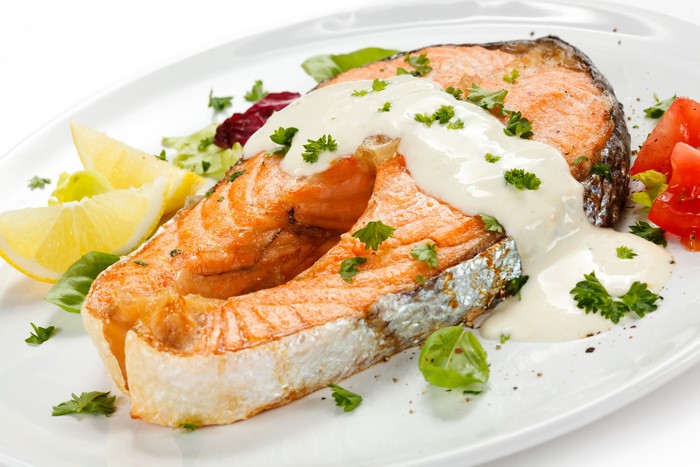 Salmon steak with cream sauce and lemon