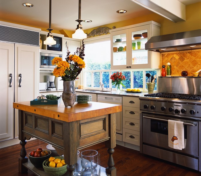 Kitchen with island, stove, and window