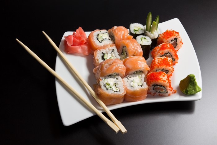 Sushi platter with chopsticks, ginger, and wasabi