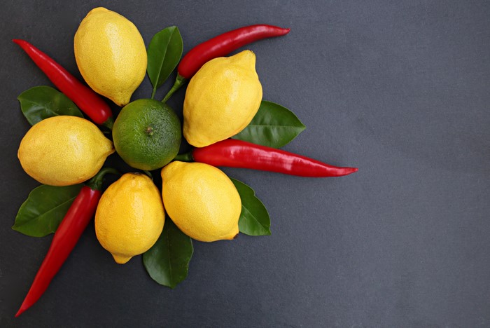 Lemons, Lime, and Chili Peppers on Gray Background