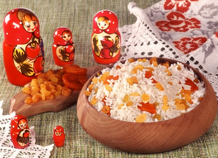 Rice with raisins and dried apricots next to Matryoshka dolls