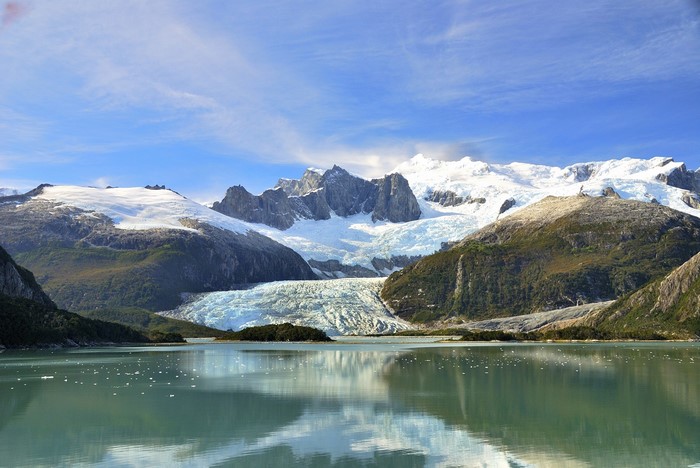 Glacier and snow-capped mountains reflected in a lake in Patagonia, Chile