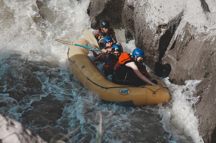 People white water rafting through a rocky gorge