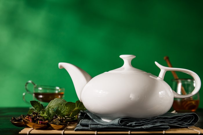 White Tea Kettle with Tea Leaves and Honey