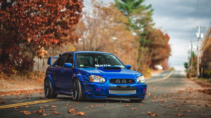 Blue Subaru Impreza STI on a Road in Autumn