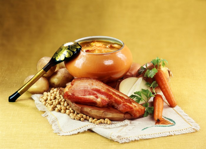 Still life with soup, bacon, vegetables, and spoon