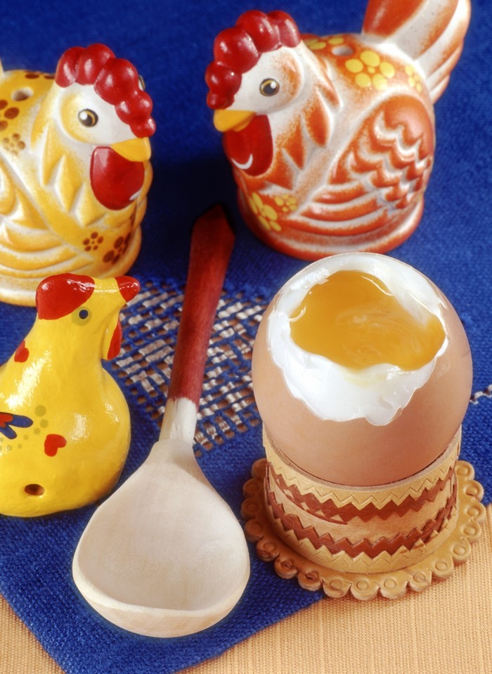 Chicken figurines and a soft-boiled egg with a spoon