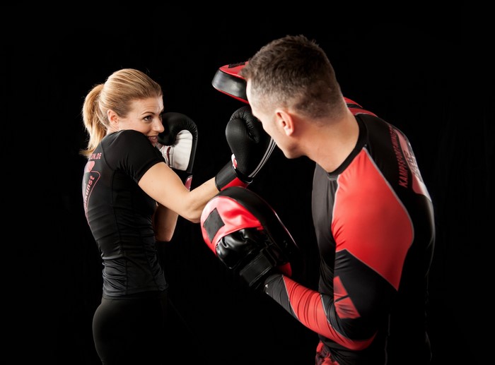 Woman boxing with a trainer