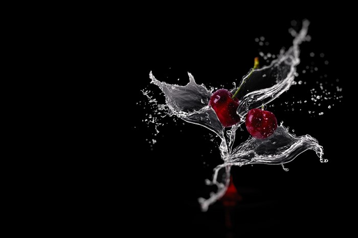 Cherries in Water Splash on Black Background