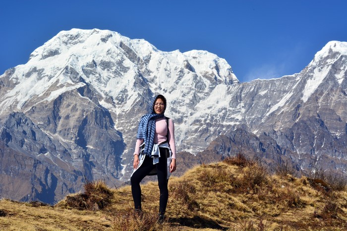 Woman in front of snow-capped Himalayas in Nepal