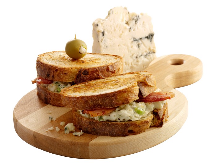 Sandwich with cheese and olive on a cutting board