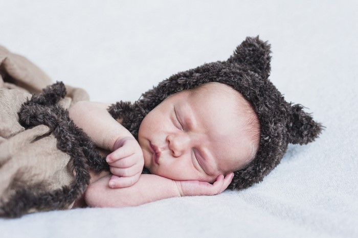 Baby sleeping in a furry hat