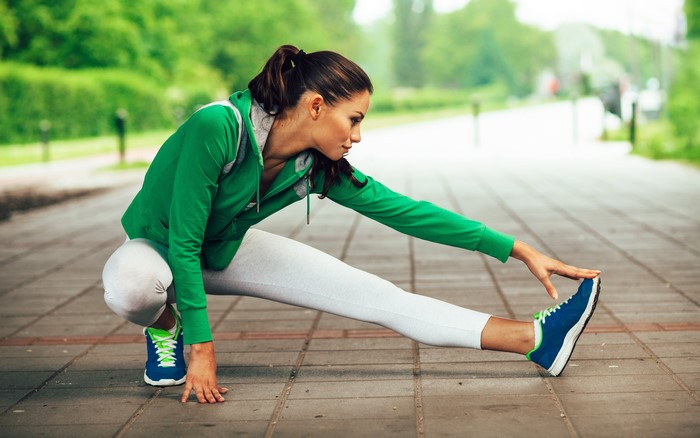 Woman stretching legs outdoors