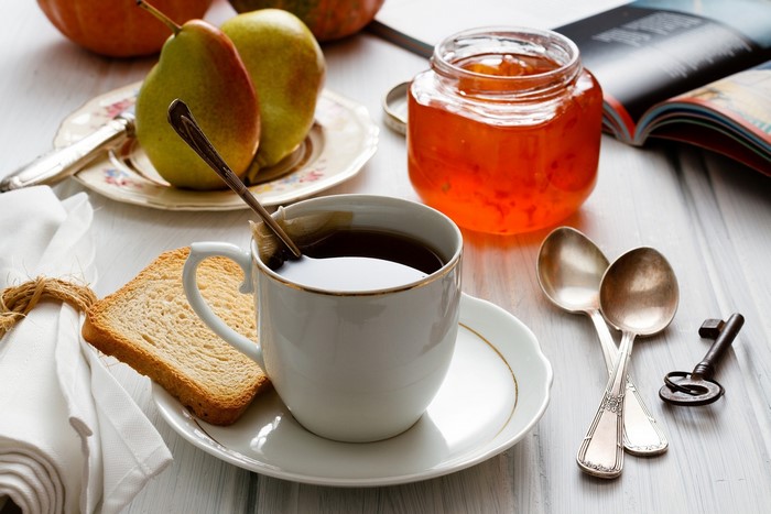 Breakfast with tea, toast, jam, pears, and a key