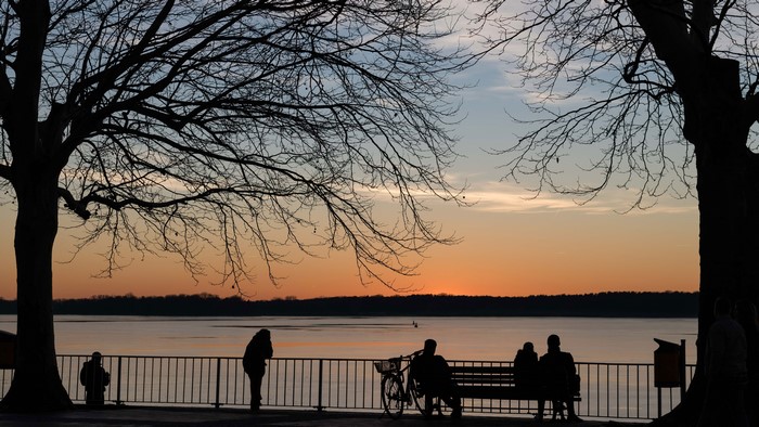 Silhouettes by the waterfront at sunset in Berlin