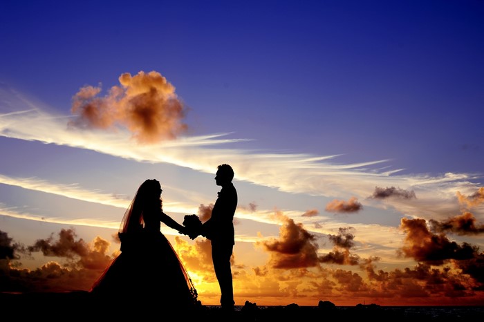 Bride and groom silhouette at sunset