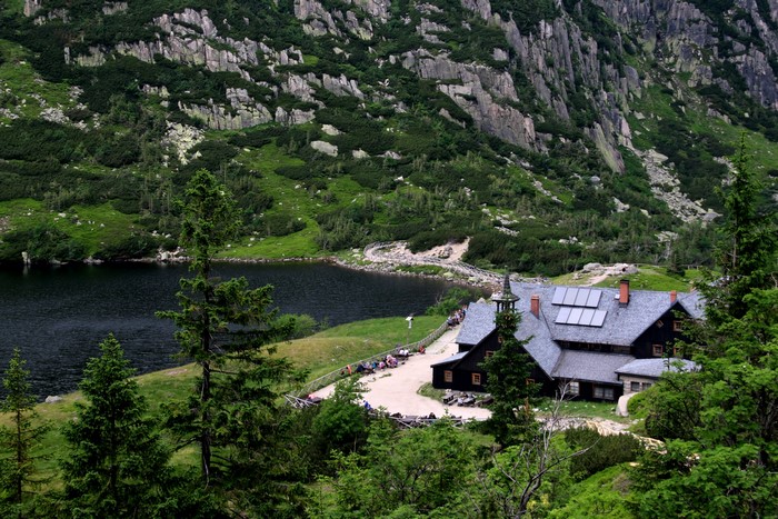 Mountain lake with a hotel and rocky slopes in Poland